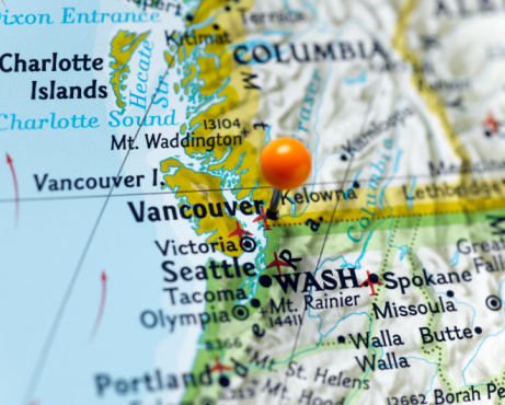 Map pin placed on Vancouver, Canada on map, close-up